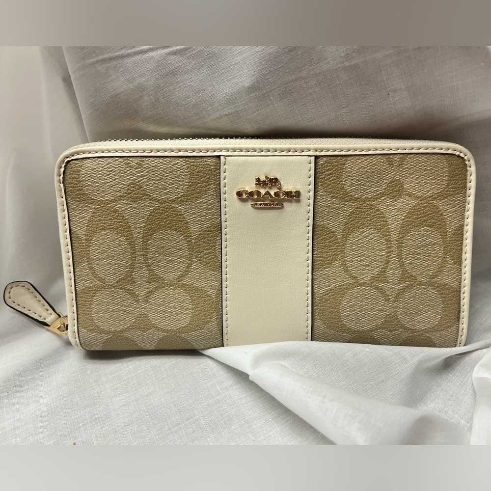 Coach full-size accordion wallet with zipper closure.